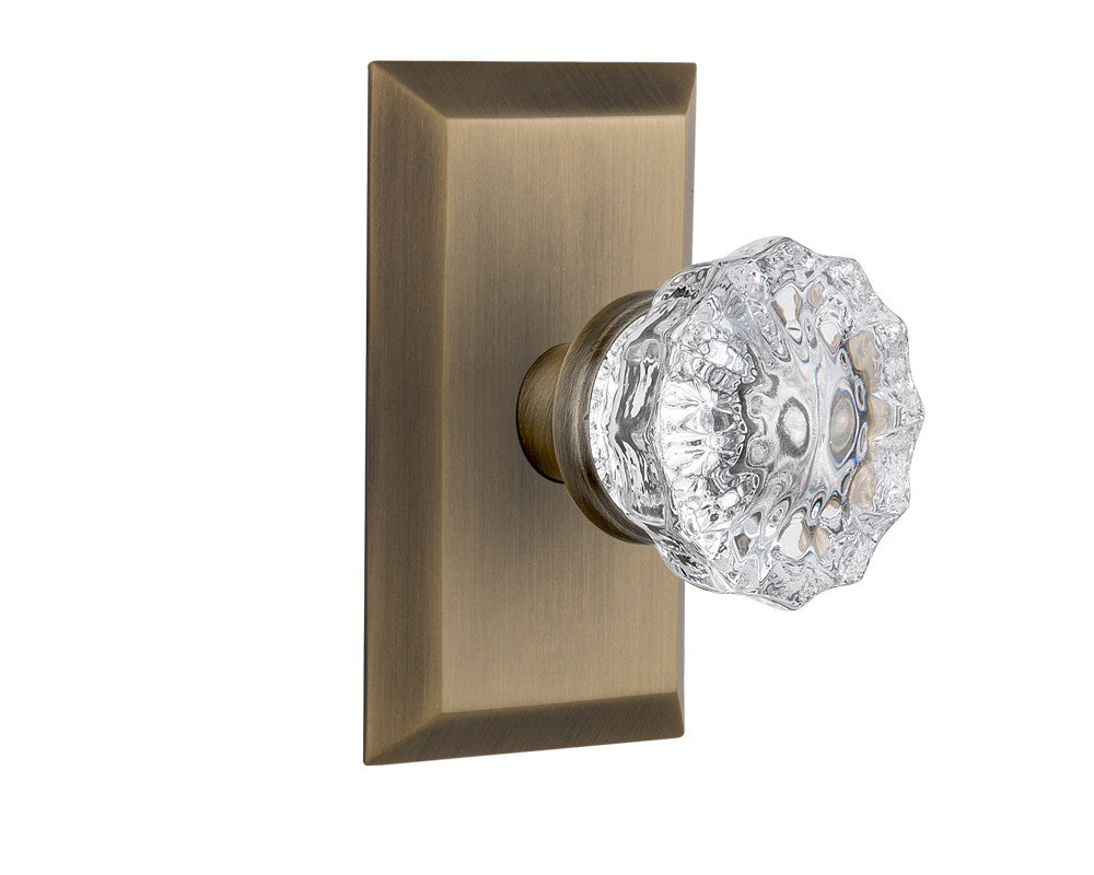 Nostalgic 713400: Studio Backplate w/Clear Crystal Glass Knob Single Dummy Door Set - Antique Brass