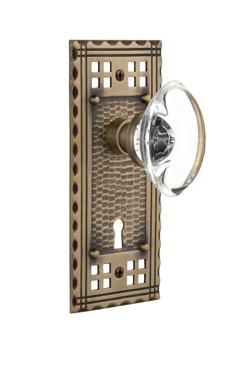 Nostalgic 715334: Craftsman Backplate w/Oval Clear Glass Crystal Knob Passage Door Set - Antique Brass