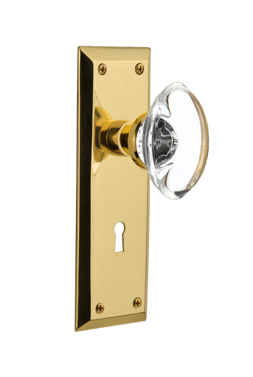 Nostalgic 717079: New York Backplate w/Oval Clear Glass Crystal Knob Privacy Door Set - Unlacquered Brass