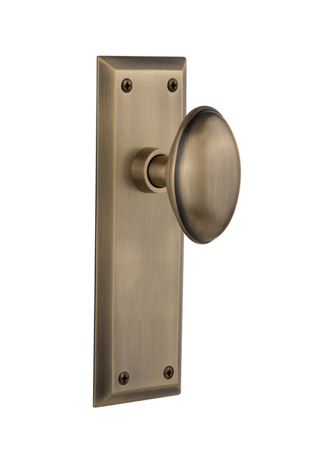 Nostalgic 733112: New York Backplate w/Homestead Knob Privacy Door Set - Antique Brass