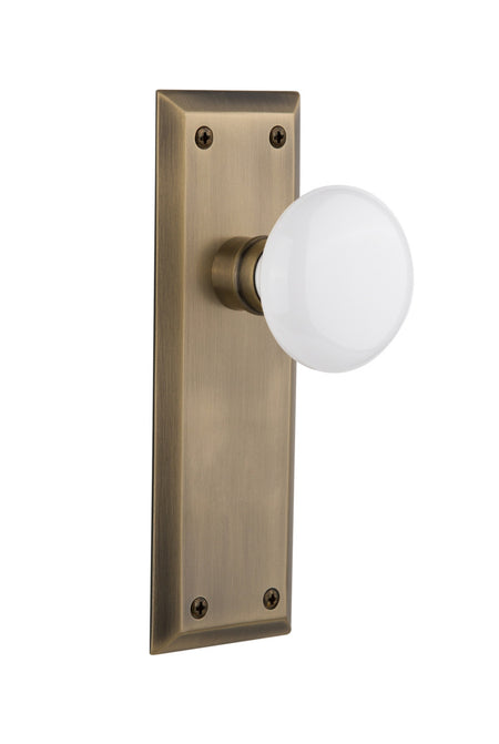 Nostalgic 733130: New York Backplate w/White Porcelain Knob Privacy Door Set - Antique Brass