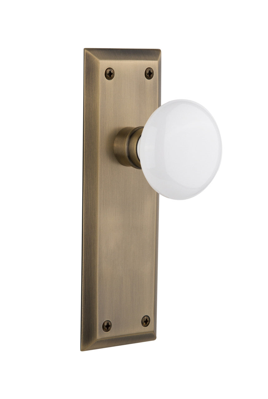 Nostalgic 733160: New York Backplate w/White Porcelain Knob Single Dummy Door Set - Antique Brass
