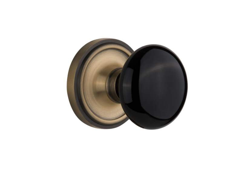 Nostalgic 710000: Classic Rosette w/Black Porcelain Knob Passage Door Set - Antique Brass