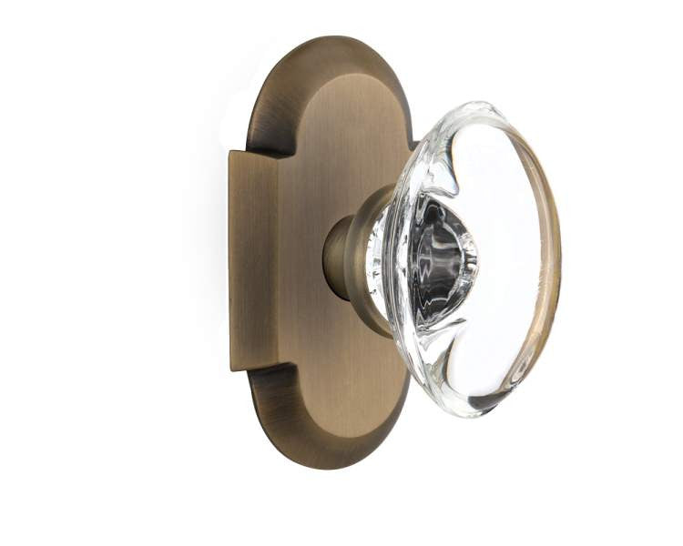 Nostalgic 712930: Cottage Backplate w/Oval Clear Glass Crystal Knob Privacy Door Set - Antique Brass