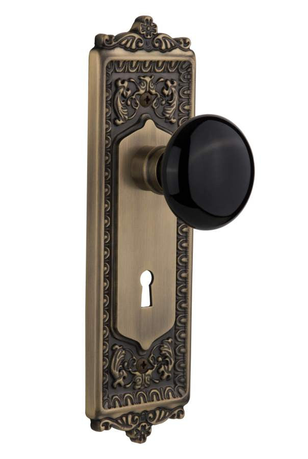 Nostalgic 710349: Egg & Dart Backplate w/Black Porcelain Knob Privacy Door Set - Antique Brass