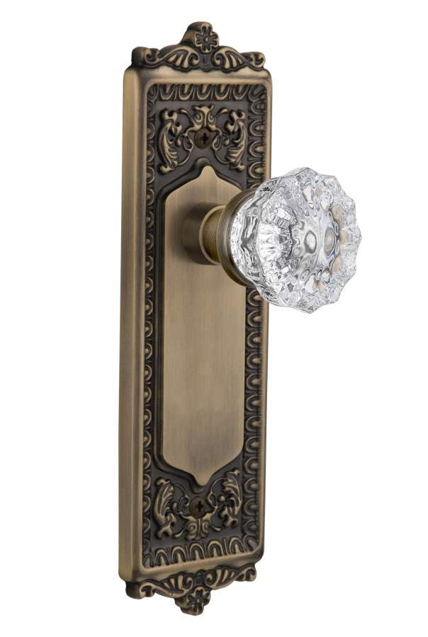 Nostalgic 701936: Egg & Dart Backplate w/Clear Crystal Glass Knob Single Dummy Door Set - Antique Brass