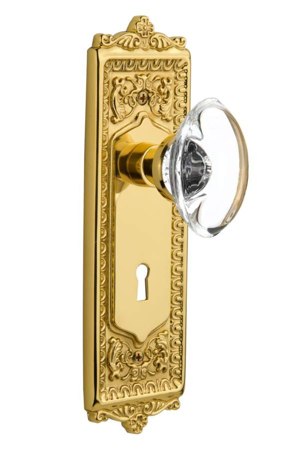 Nostalgic 702874: Egg & Dart Backplate w/Oval Clear Glass Crystal Knob Single Dummy Door Set - Unlacquered Brass