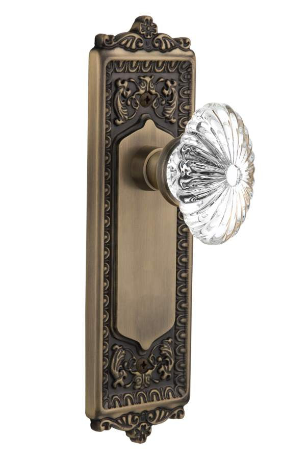 Nostalgic 711863: Egg & Dart Backplate w/Oval Fluted Clear Glass Crystal Knob Single Dummy Door Set - Antique Brass