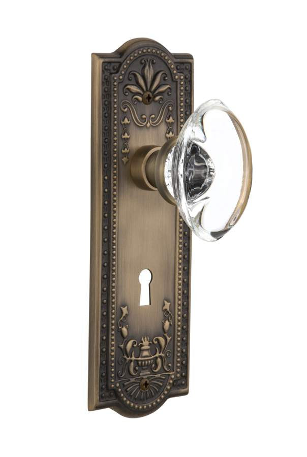 Nostalgic 711388: Meadows Backplate w/Oval Clear Glass Crystal Knob Passage Door Set - Antique Brass