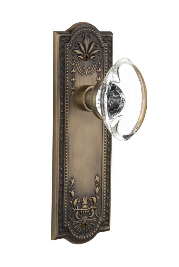 Nostalgic 711334: Meadows Backplate w/Oval Clear Glass Crystal Knob Passage Door Set - Antique Brass