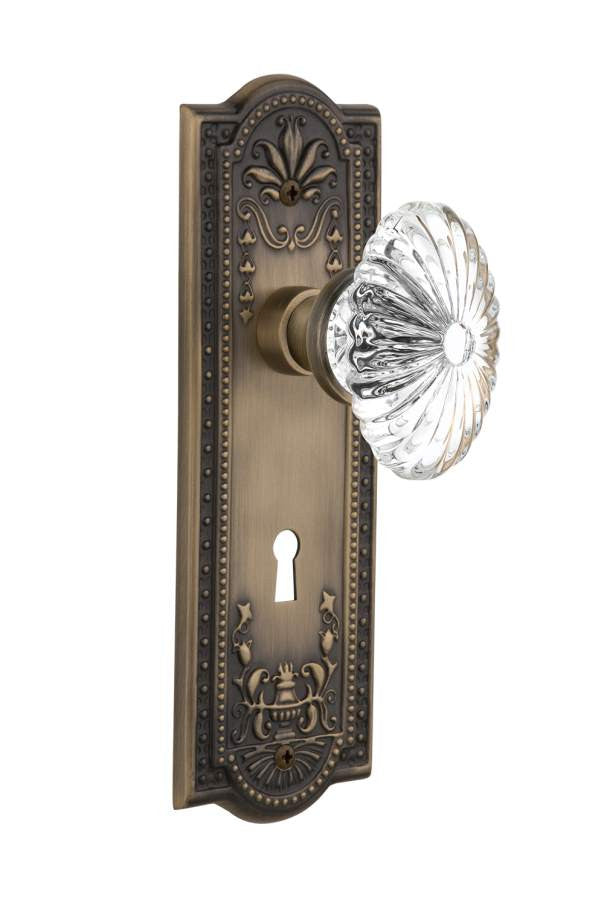 Nostalgic 711828: Meadows Backplate w/Oval Fluted Clear Glass Crystal Knob Passage Door Set - Antique Brass