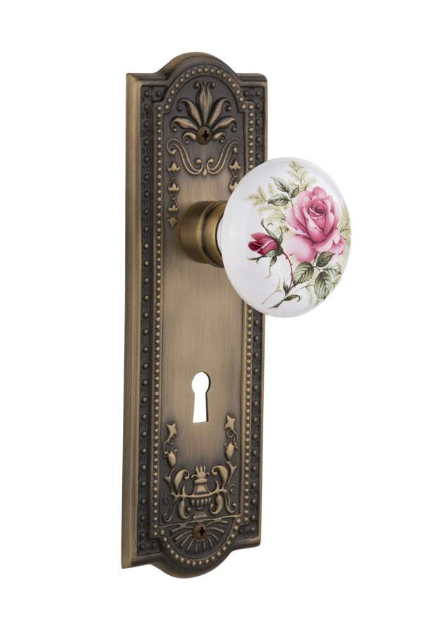 Nostalgic 710948: Meadows Backplate w/White Rose Porcelain Knob Passage Door Set - Antique Brass
