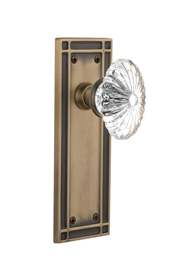 Nostalgic 716234: Mission Backplate w/Oval Fluted Clear Glass Crystal Knob Privacy Door Set - Antique Brass