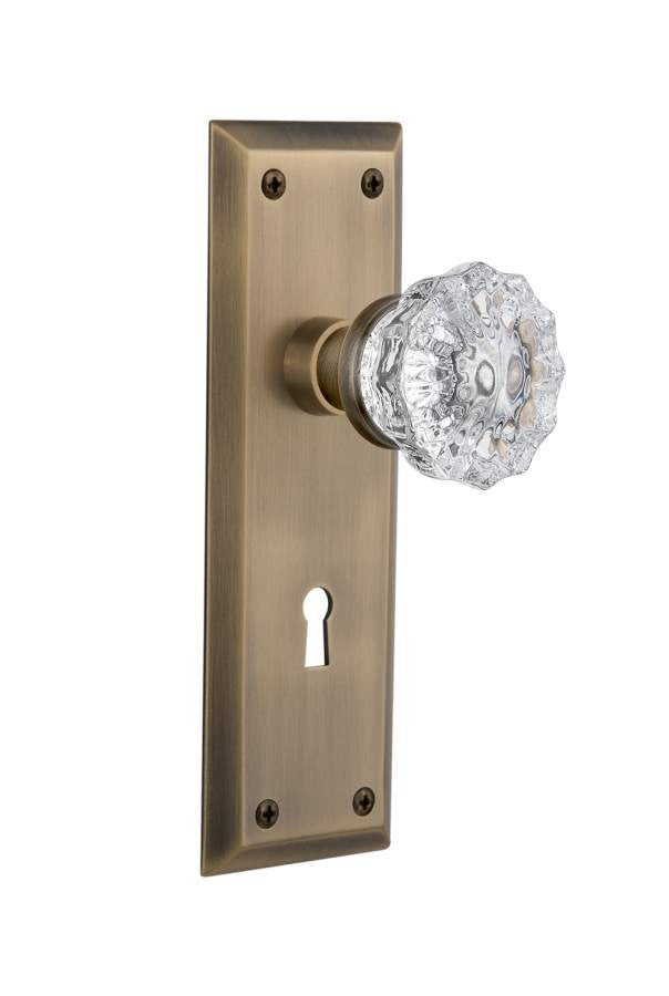 Nostalgic 704564: New York Backplate w/Clear Crystal Glass Knob Passage Door Set - Antique Brass