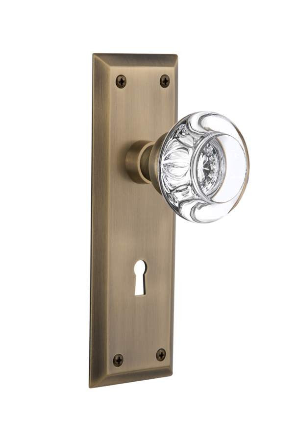 Nostalgic 712371: New York Backplate w/Round Clear Glass Crystal Knob Single Dummy Door Set - Antique Brass