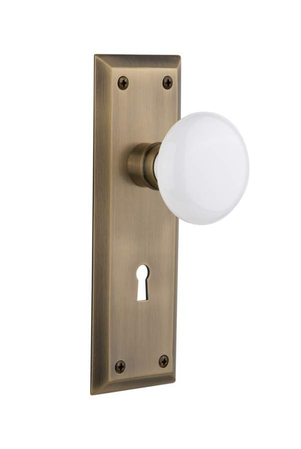 Nostalgic 704635: New York Backplate w/White Porcelain Knob Privacy Door Set - Antique Brass