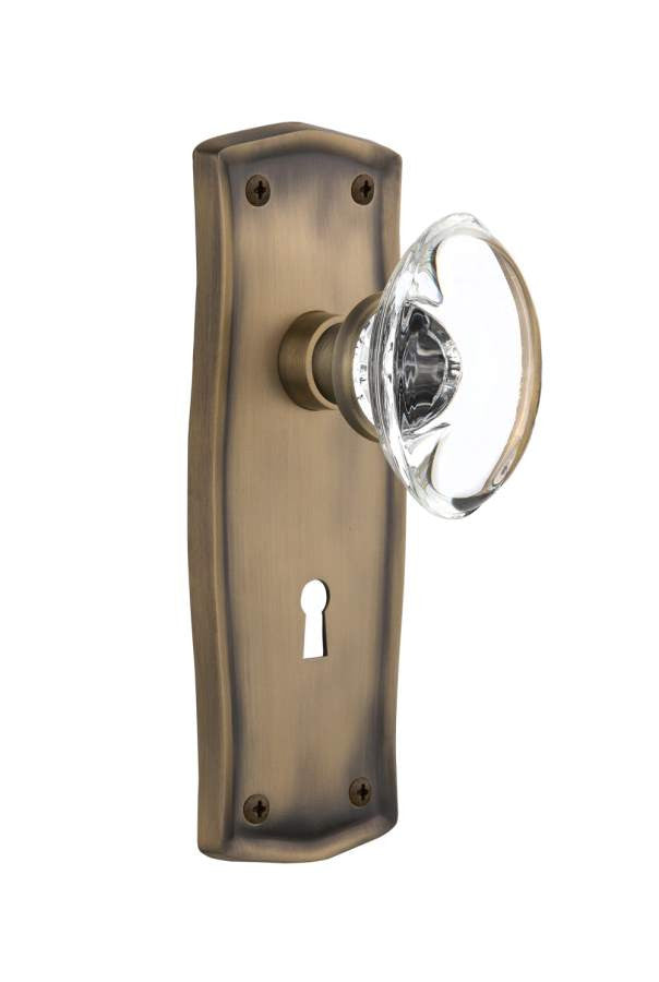 Nostalgic 711690: Prairie Backplate w/Oval Clear Glass Crystal Knob Privacy Door Set - Antique Brass