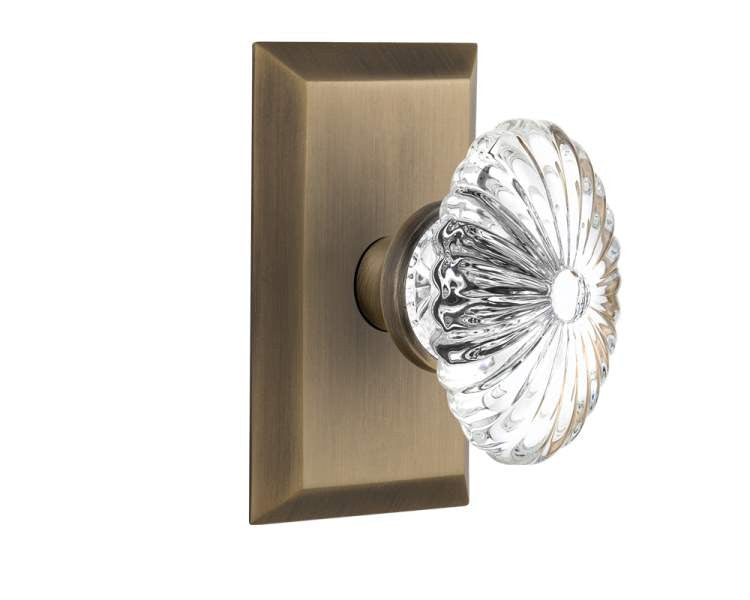 Nostalgic 713441: Studio Backplate w/Oval Fluted Clear Glass Crystal Knob Single Dummy Door Set - Antique Brass