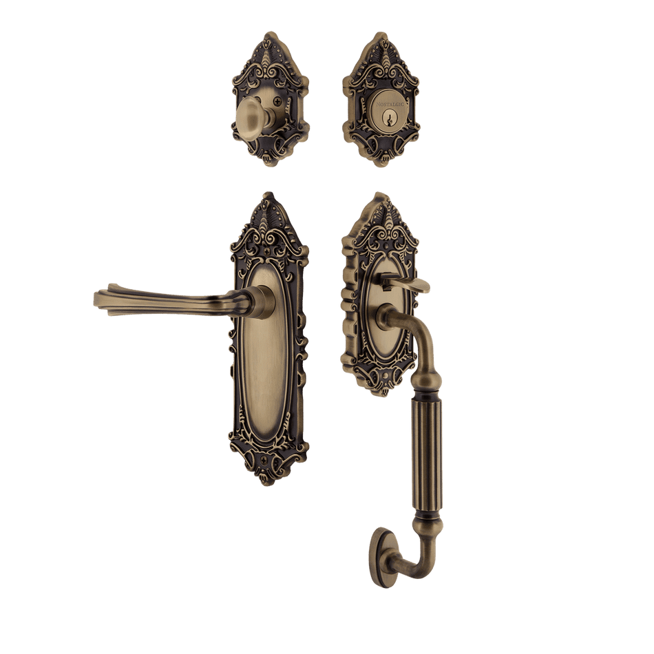 Nostalgic 769242: Entry Lockset w/Victorian Backplate, F-Grip Exterior Handle and Fleur Interior Lever - Antique Brass