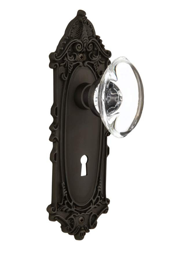 Nostalgic 711412: Victorian Backplate w/Oval Clear Glass Crystal Knob Passage Door Set - Oil-Rubbed Bronze